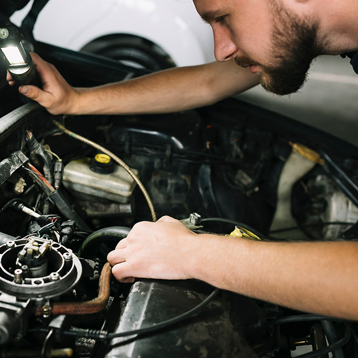 mechanic inspecting engine bay